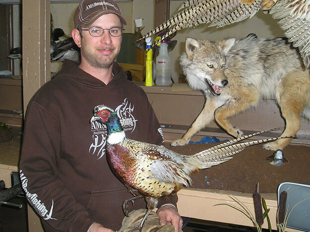 Image of man showing off taxidermized pheasant